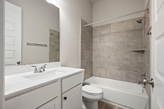 14505 Kira Ln, Manor, TX 78653 - full bath featuring toilet, vanity, shower / bath combination, wood finished floors, and a textured wall