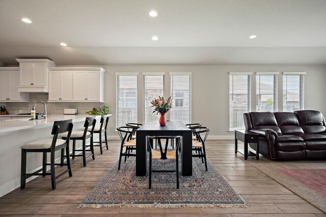 14505 Kira Ln, Manor, TX 78653 - dining room with recessed lighting, healthy amount of natural light, wood finished floors, and baseboards