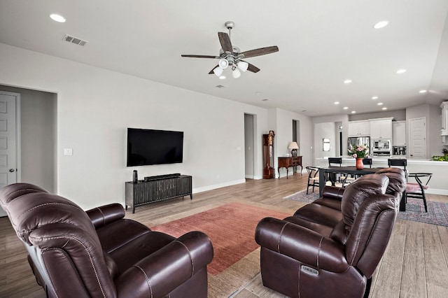 14505 Kira Ln, Manor, TX 78653 - living room with a ceiling fan, light wood-style floors, recessed lighting, and baseboards