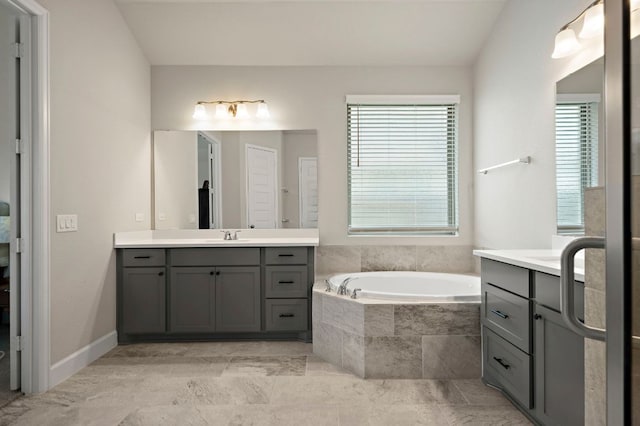 14505 Kira Ln, Manor, TX 78653 - bathroom featuring two vanities and a garden tub