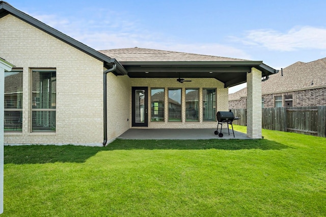 14505 Kira Ln, Manor, TX 78653 - back of property featuring ceiling fan, a patio, brick siding, and roof with shingles