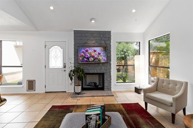 8807 Honeysuckle Trl, Austin, TX 78759 - tiled living room with vaulted ceiling, plenty of natural light, a fireplace, and recessed lighting