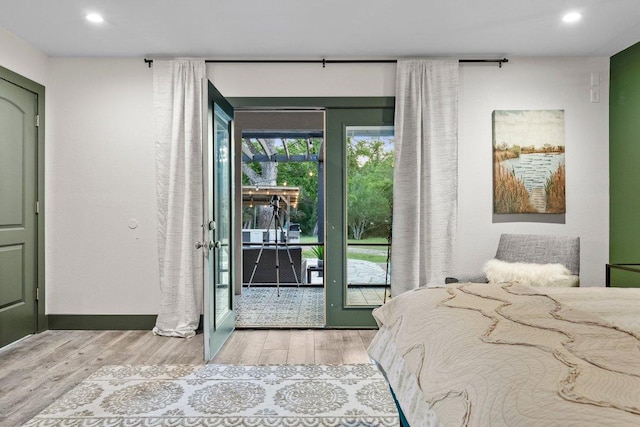 bedroom featuring wood finished floors, access to outside, recessed lighting, and baseboards