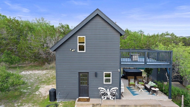 rear view of house featuring a patio and a deck