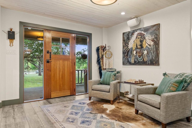 foyer entrance with plenty of natural light, wood ceiling, light wood-style flooring, and recessed lighting