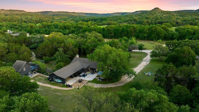 view of subject property featuring a forest