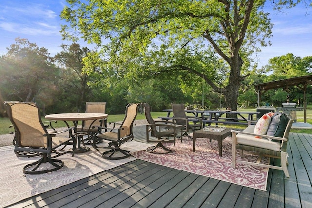 deck featuring outdoor dining space and view of scattered trees