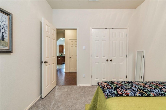 carpeted bedroom with a closet