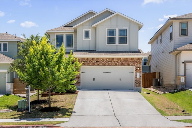 1203 Diggy Dr, Austin, TX 78748 - view of front of house featuring board and batten siding, brick siding, driveway, central AC unit, and a garage