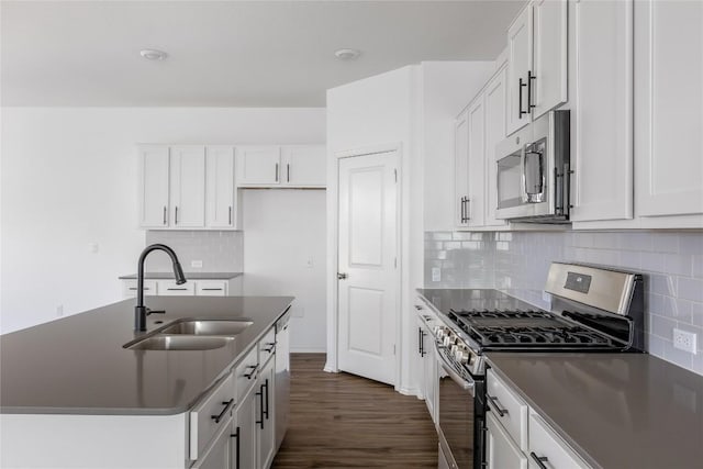 1203 Diggy Dr, Austin, TX 78748 - kitchen with appliances with stainless steel finishes, a sink, dark countertops, dark wood-style floors, and decorative backsplash
