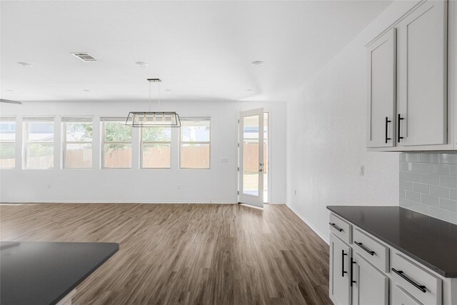 1203 Diggy Dr, Austin, TX 78748 - unfurnished living room with dark wood finished floors and healthy amount of natural light