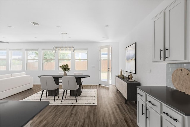 1203 Diggy Dr, Austin, TX 78748 - dining area with dark wood finished floors, healthy amount of natural light, and baseboards