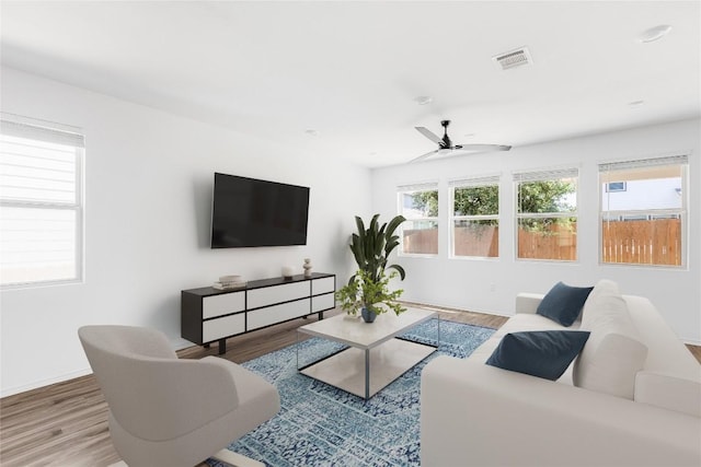 1203 Diggy Dr, Austin, TX 78748 - living area featuring wood finished floors, a ceiling fan, and baseboards