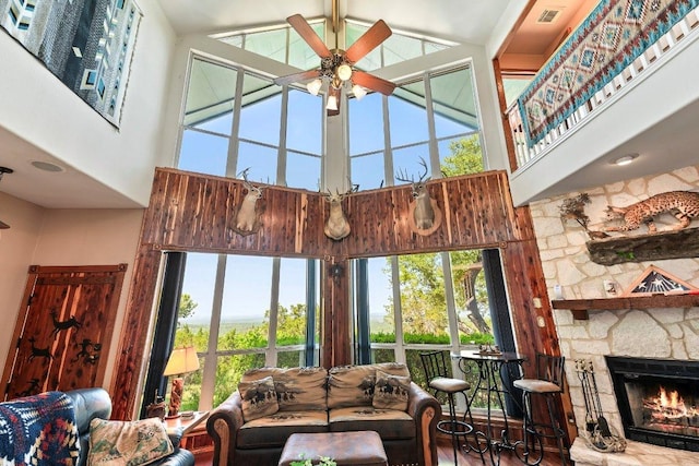 9038 Eagles Vw, Spring Branch, TX 78070 - living area with high vaulted ceiling, a ceiling fan, plenty of natural light, a fireplace, and wood finished floors