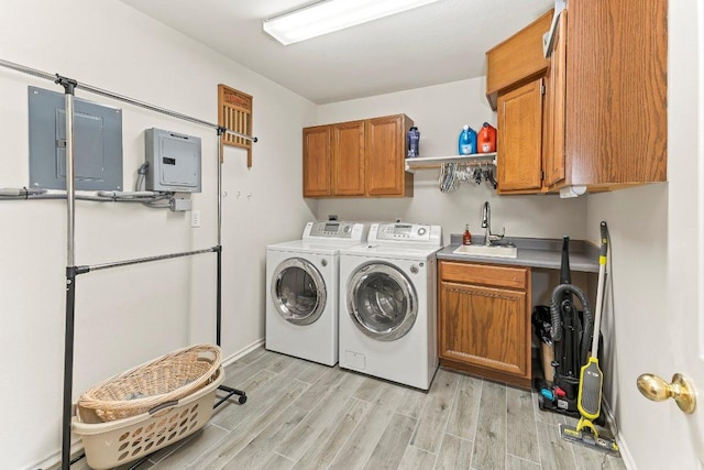 9038 Eagles Vw, Spring Branch, TX 78070 - laundry area with cabinet space, washing machine and clothes dryer, electric panel, and light wood-type flooring