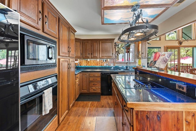 9038 Eagles Vw, Spring Branch, TX 78070 - kitchen with black appliances, wood finished floors, a sink, and brown cabinetry