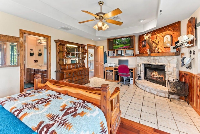 9038 Eagles Vw, Spring Branch, TX 78070 - bedroom with a stone fireplace, light tile patterned flooring, a raised ceiling, and ensuite bathroom