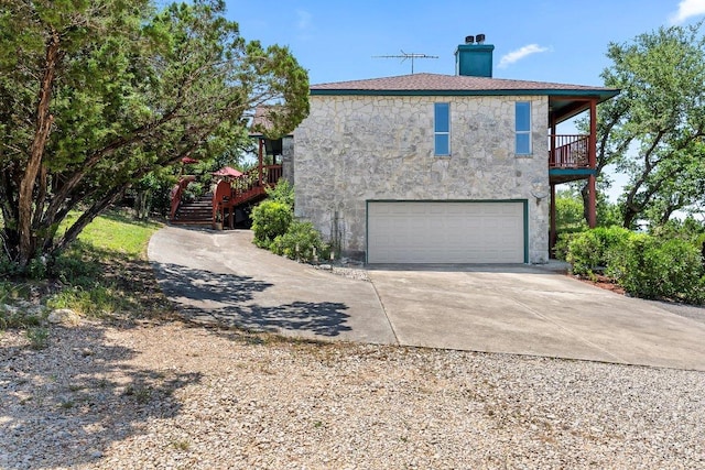 9038 Eagles Vw, Spring Branch, TX 78070 - view of side of property featuring a chimney, driveway, a balcony, stairs, and stucco siding