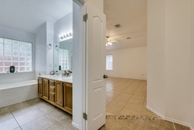 full bath with tile patterned flooring, double vanity, a ceiling fan, and a bath