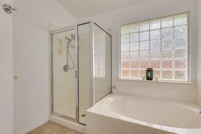 full bath with a stall shower, a garden tub, and tile patterned flooring