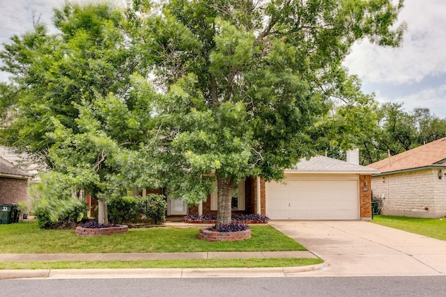 obstructed view of property featuring an attached garage, concrete driveway, a front lawn, brick siding, and a chimney