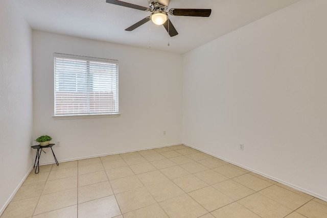 unfurnished room with a ceiling fan and baseboards