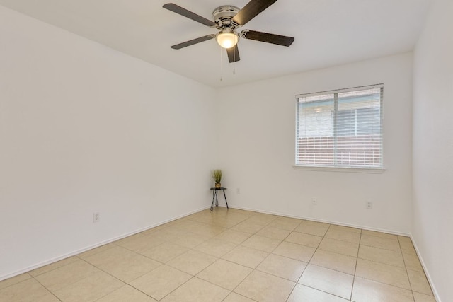 empty room featuring a ceiling fan, baseboards, and light tile patterned flooring