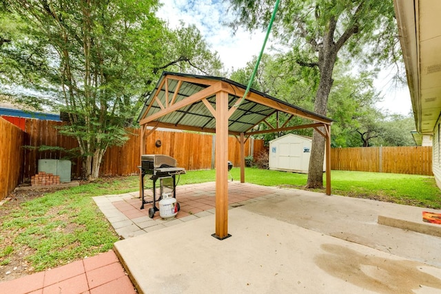 view of patio / terrace featuring a shed, an outdoor structure, grilling area, and a gazebo