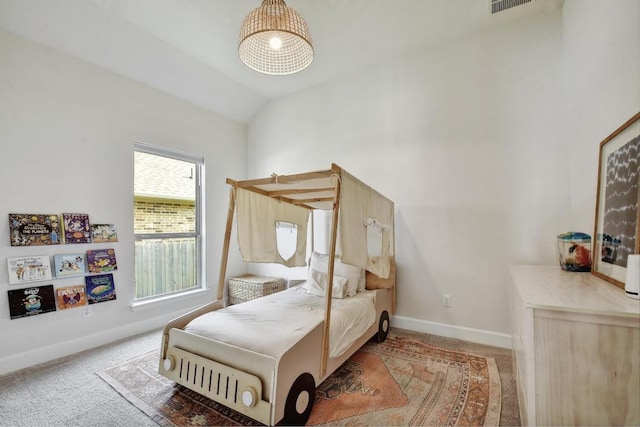 carpeted bedroom with baseboards and lofted ceiling