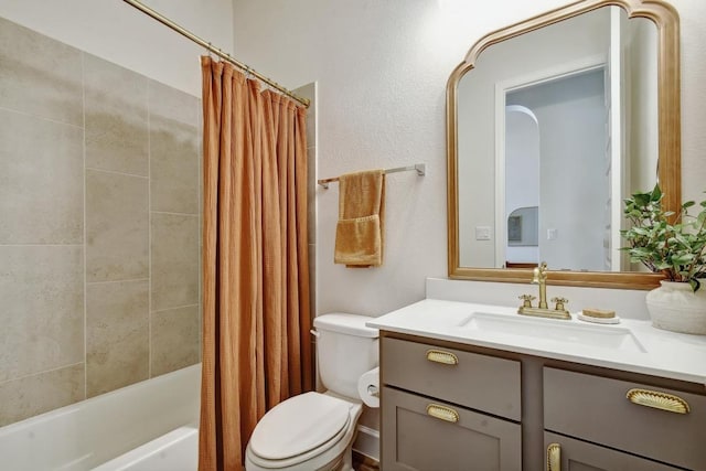 bathroom featuring toilet, vanity, and shower / bath combo