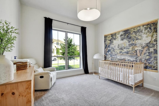 carpeted bedroom featuring a nursery area, multiple windows, and baseboards