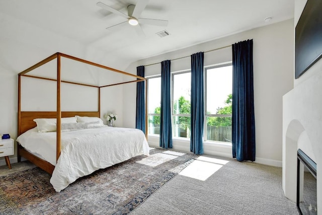 bedroom with arched walkways, vaulted ceiling, ceiling fan, carpet, and baseboards