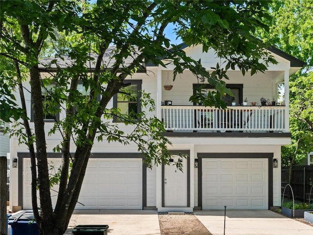 5209 Evans Ave, Austin, TX 78751 - view of front facade featuring an attached garage, driveway, and a balcony
