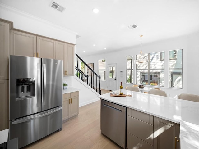 5209 Evans Ave, Austin, TX 78751 - kitchen featuring appliances with stainless steel finishes, light wood-style floors, recessed lighting, a chandelier, and pendant lighting