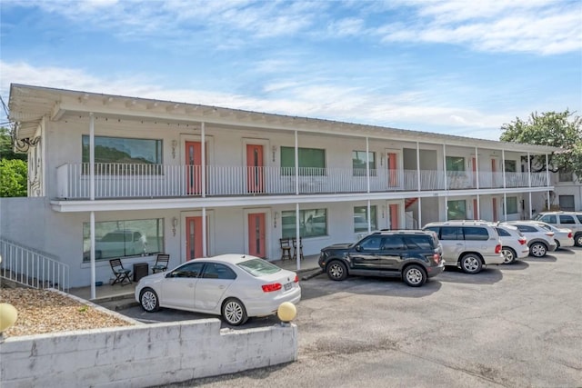 view of property featuring uncovered parking