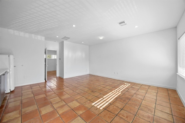 unfurnished living room with recessed lighting, light tile patterned floors, and baseboards