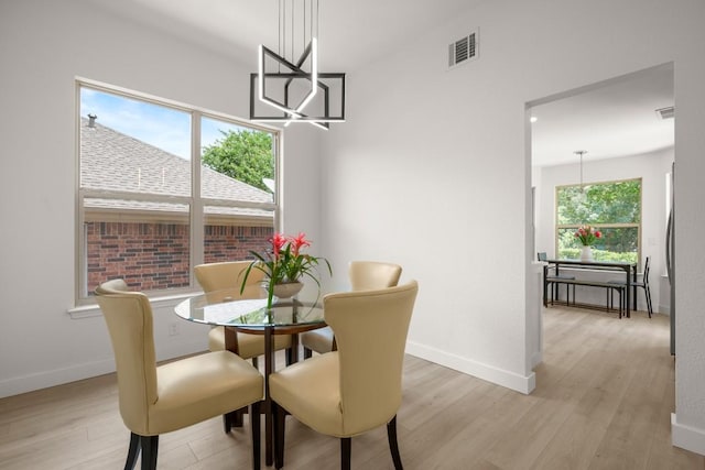 9127 Edwardson Ln, Austin, TX 78749 - dining space featuring light wood-style flooring and a chandelier