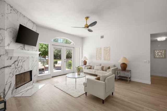 9127 Edwardson Ln, Austin, TX 78749 - living room featuring a ceiling fan, wood finished floors, and a high end fireplace