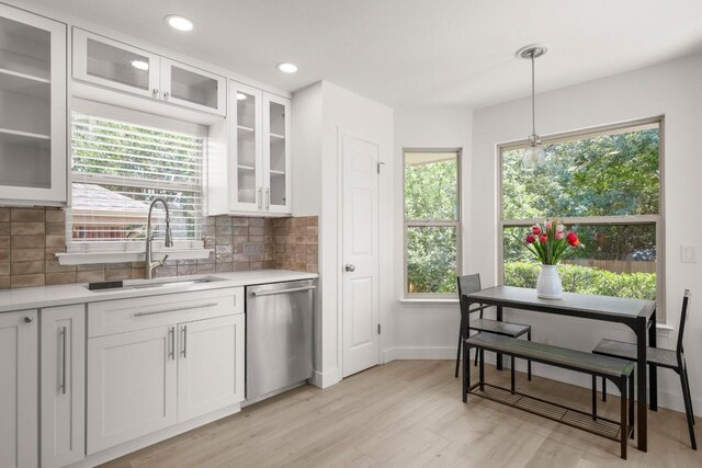 9127 Edwardson Ln, Austin, TX 78749 - kitchen with stainless steel dishwasher, light countertops, white cabinets, and recessed lighting