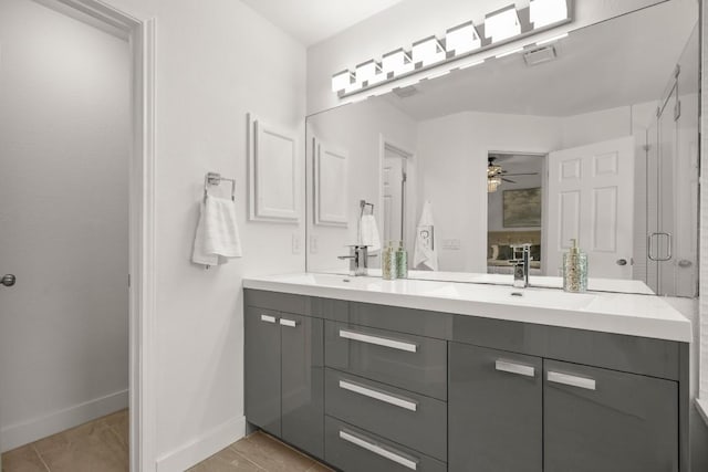9127 Edwardson Ln, Austin, TX 78749 - bathroom featuring double vanity, a ceiling fan, a stall shower, and tile patterned floors