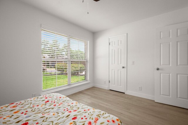 9127 Edwardson Ln, Austin, TX 78749 - bedroom with multiple windows, light wood finished floors, and ceiling fan