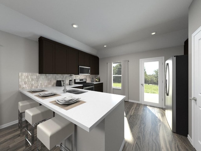 835 Sun Grove Trl, Georgetown, TX 78628 - kitchen featuring appliances with stainless steel finishes, a sink, light countertops, dark wood-style floors, and recessed lighting