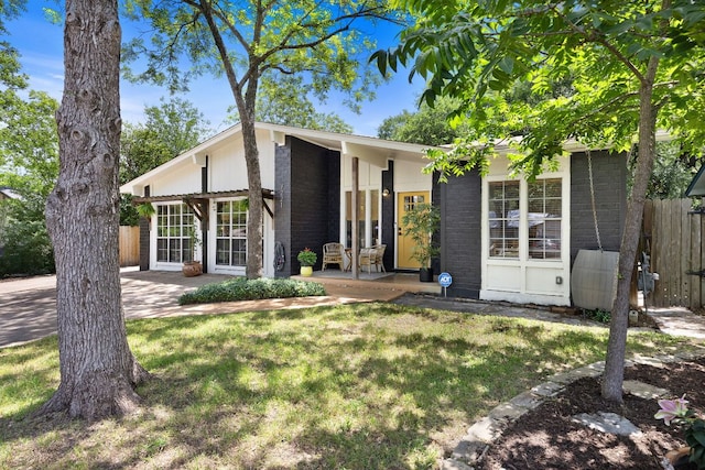 mid-century modern home featuring brick siding
