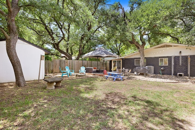 view of yard featuring central AC and a patio