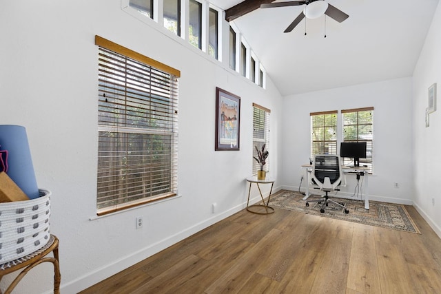 office space with wood finished floors, baseboards, ceiling fan, and high vaulted ceiling
