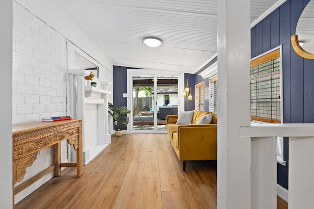 hall with wood finished floors and lofted ceiling