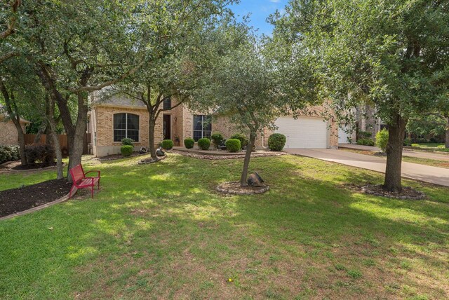 8105 Red Bird Ct, Austin, TX 78726 - view of property hidden behind natural elements featuring concrete driveway, an attached garage, a front lawn, and brick siding