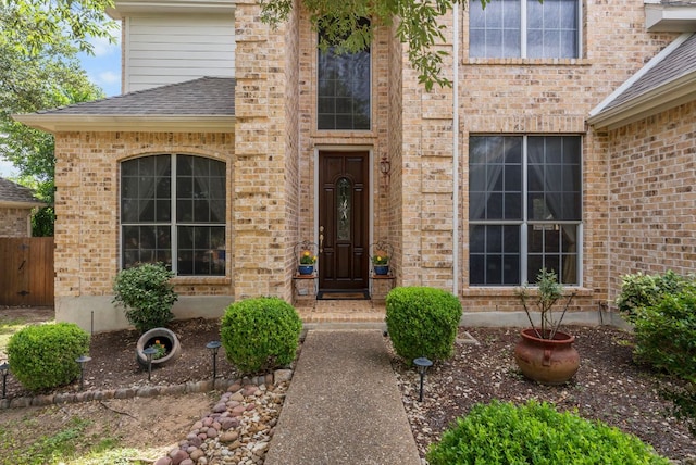 8105 Red Bird Ct, Austin, TX 78726 - doorway to property featuring brick siding and a shingled roof
