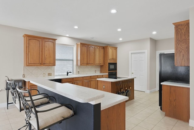 8105 Red Bird Ct, Austin, TX 78726 - kitchen featuring black appliances, decorative backsplash, a kitchen island, and recessed lighting
