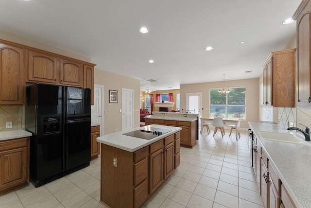 8105 Red Bird Ct, Austin, TX 78726 - kitchen featuring black appliances, a kitchen island, brown cabinets, light countertops, and recessed lighting